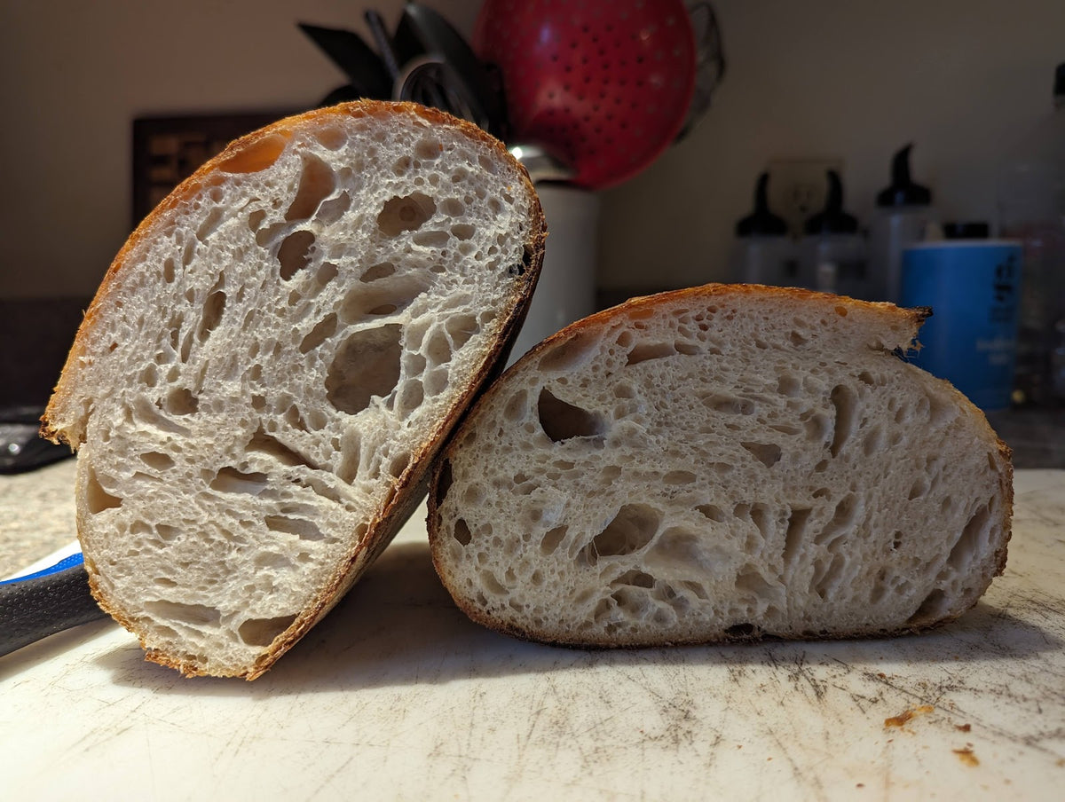 Sourdough boule sliced showing open crumb